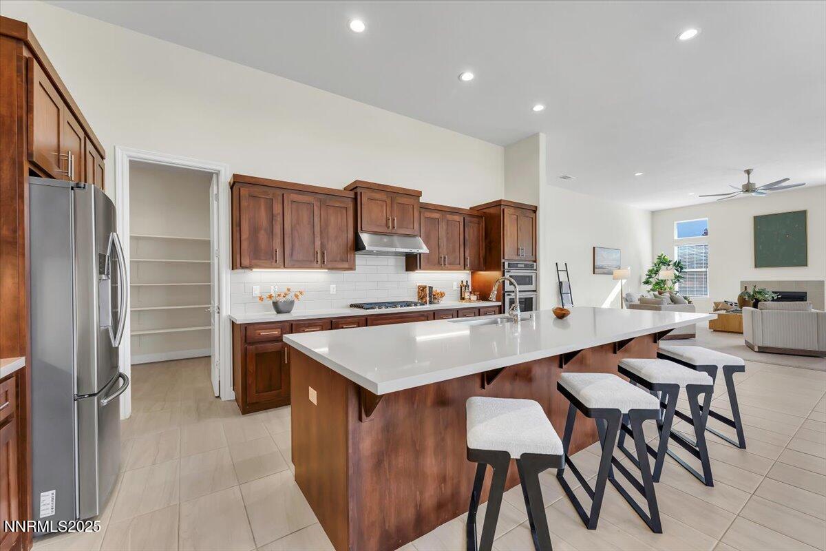 9040 Boomtown Garson Road Verdi, NV 89439 - Photo 15 of 35 a large kitchen with kitchen island a table and chairs in it