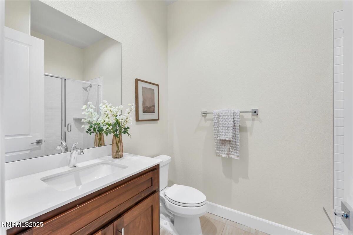9040 Boomtown Garson Road Verdi, NV 89439 - Photo 26 of 35 a bathroom with a granite countertop sink a toilet and mirror