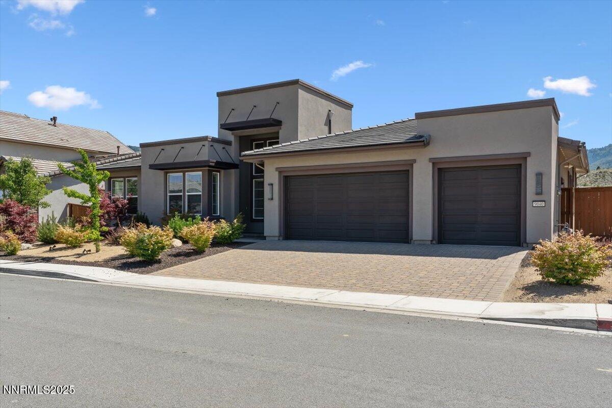 9040 Boomtown Garson Road Verdi, NV 89439 - Photo 3 of 35 a front view of a house with a yard and garage