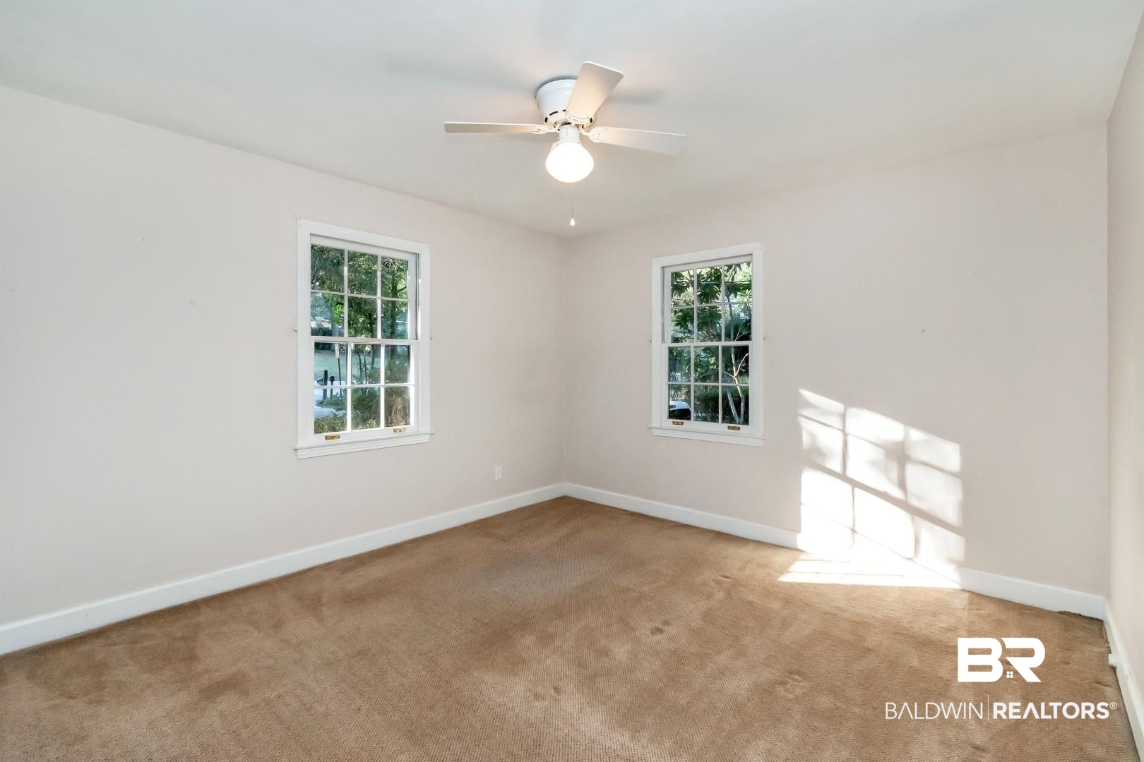 308 Brawood Drive Mobile, AL 36608 - Photo 17 of 33 Empty room featuring ceiling fan, light colored carpet, and plenty of natural light