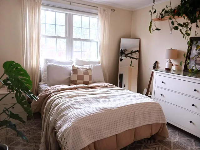 a bedroom with a bed and with windows