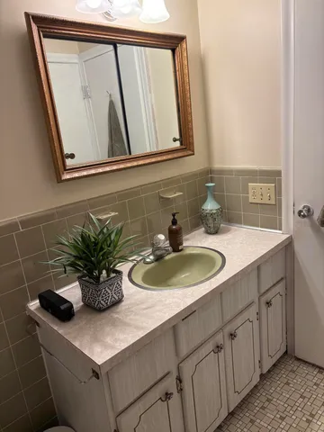 a kitchen with sink cabinets and white appliances