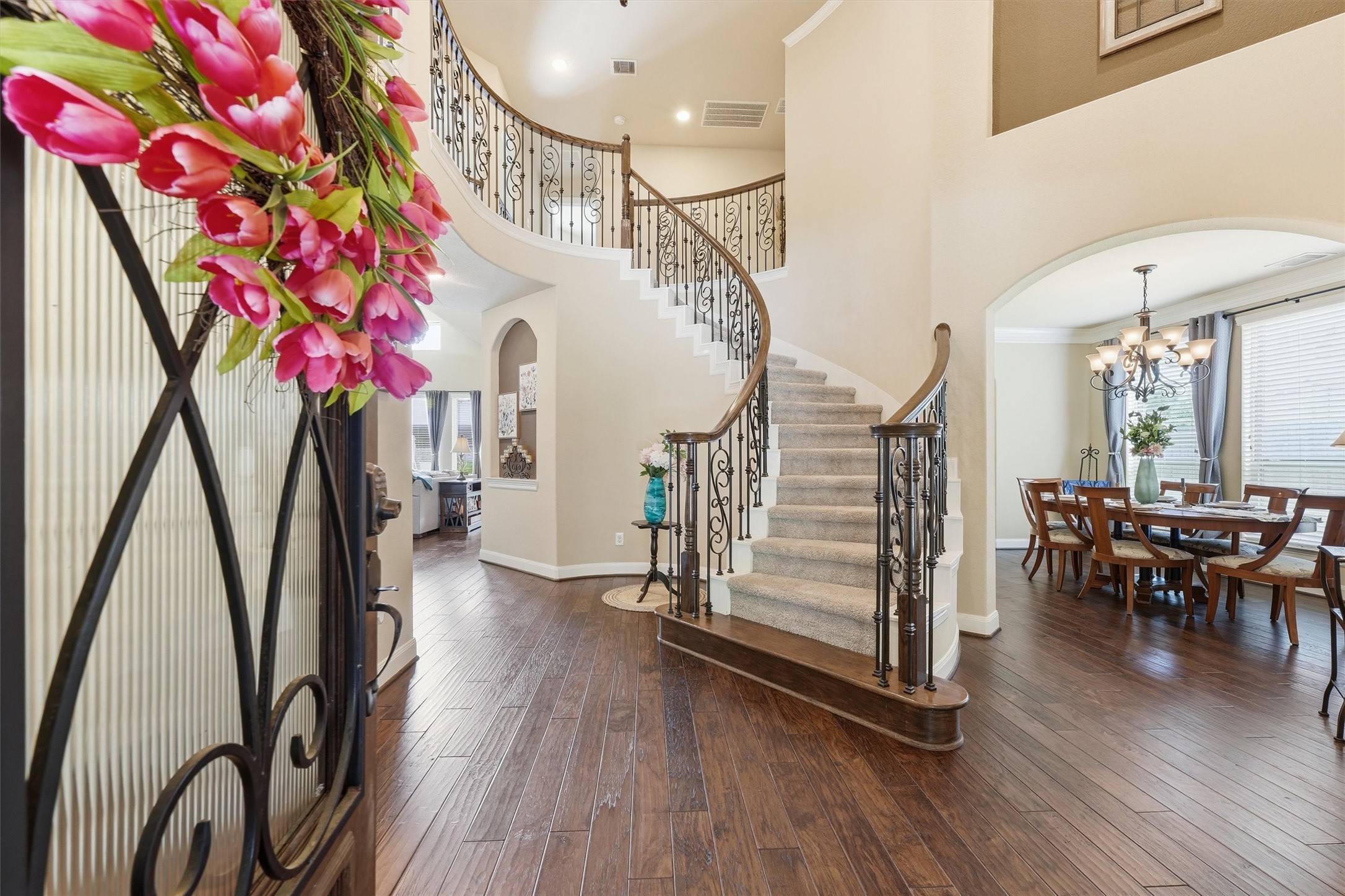 17710 Rough River Court Humble, TX 77346 - Photo 4 of 38 This inviting home features a grand entrance with a sweeping staircase, elegant iron railings, and rich hardwood floors. The open layout leads to a bright dining area, perfect for entertaining.