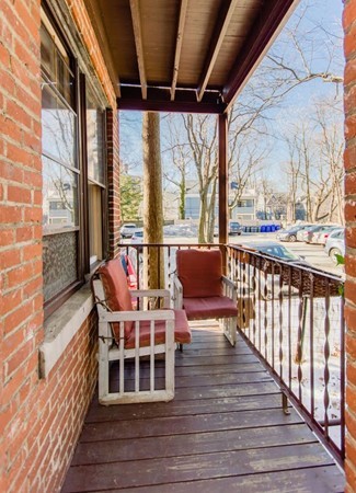 35 Winslow Road, Unit 1 Brookline, MA 02446 - Photo 4 of 10 a balcony with wooden floor and furniture