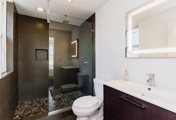 35 Winslow Road, Unit 1 Brookline, MA 02446 - Photo 7 of 10 a bathroom with a sink a toilet and shower