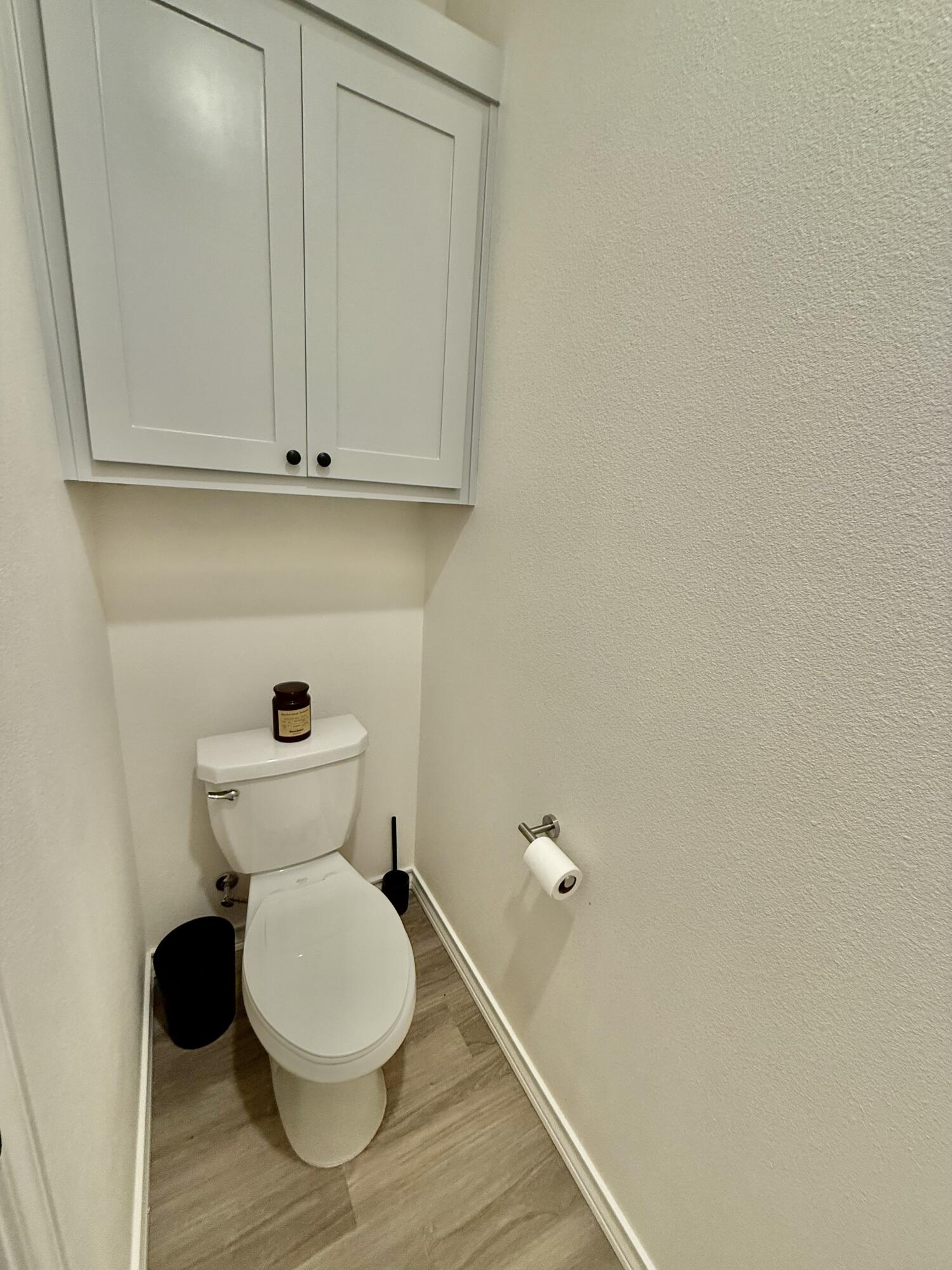 5825 Virginia Avenue Lubbock, TX 79407 - Photo 13 of 29 a bathroom with a toilet and a mirror