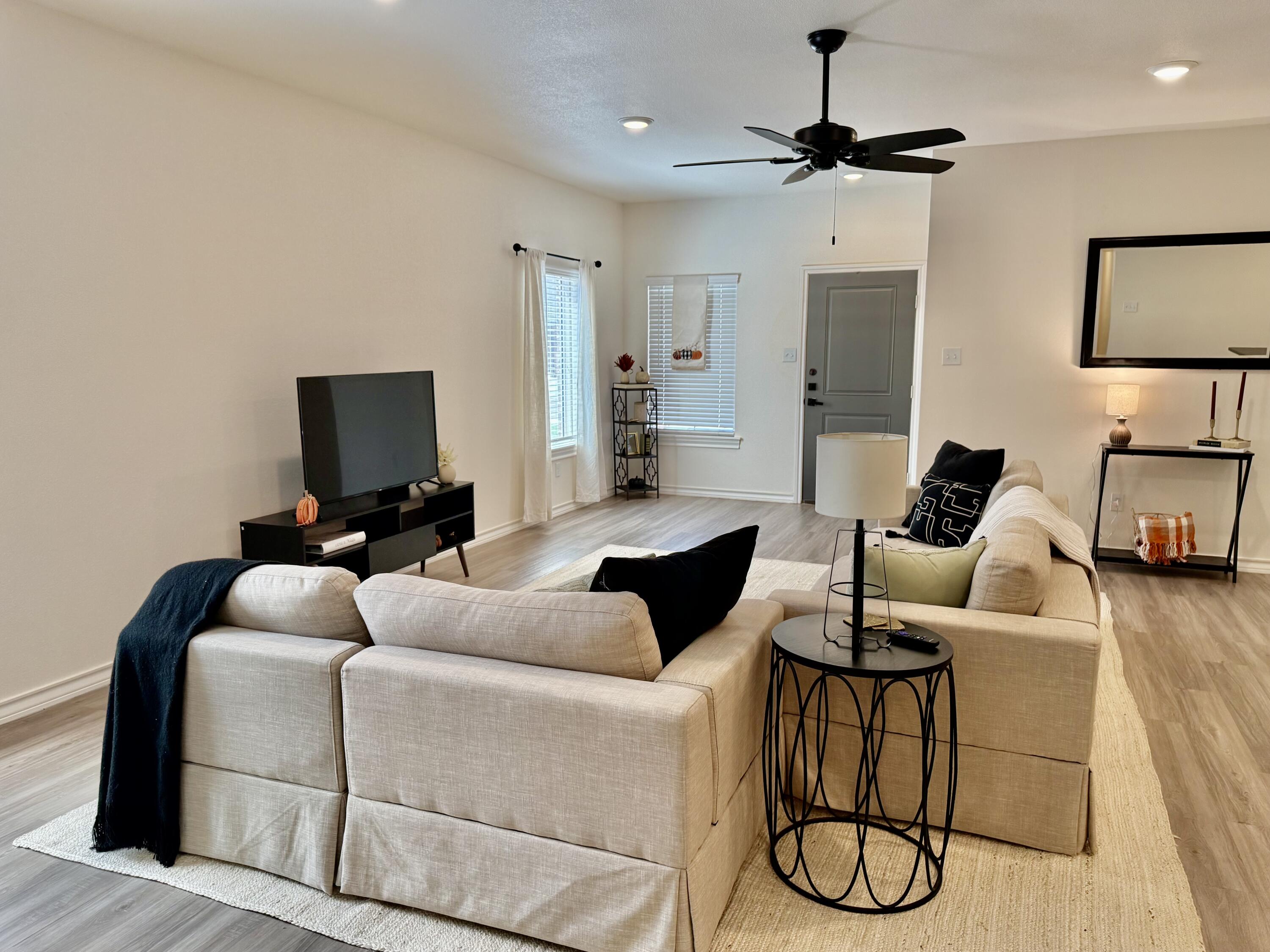 5825 Virginia Avenue Lubbock, TX 79407 - Photo 4 of 29 a living room with furniture and a flat screen tv