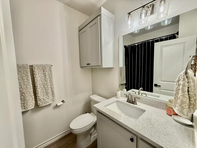 a bathroom with a double vanity sink mirror and shower
