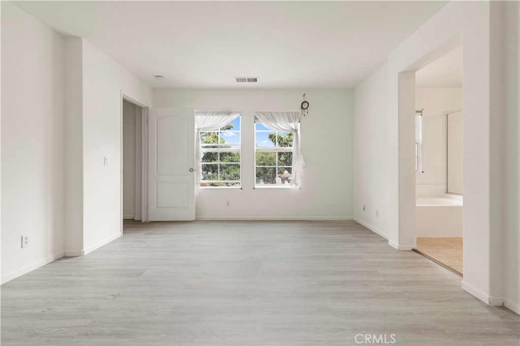 8541 Oak Barrel Place, Unit 2 Rancho Cucamonga, CA 91730 - Photo 17 of 50 an empty room with windows and closet