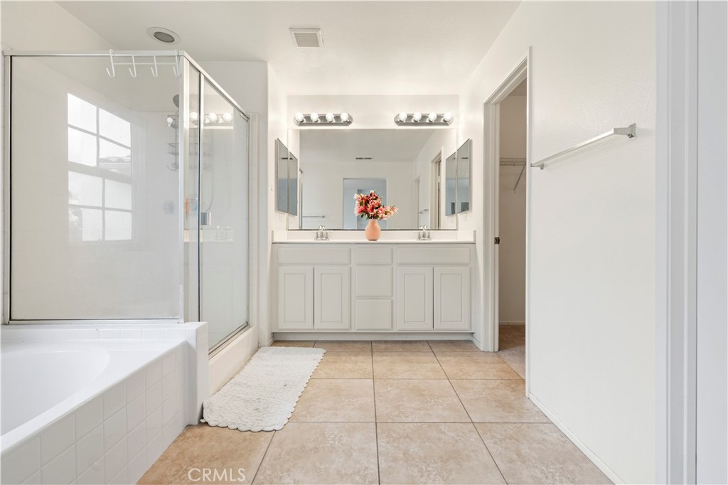 8541 Oak Barrel Place, Unit 2 Rancho Cucamonga, CA 91730 - Photo 18 of 50 a view of a bathroom with a tub shower and sink