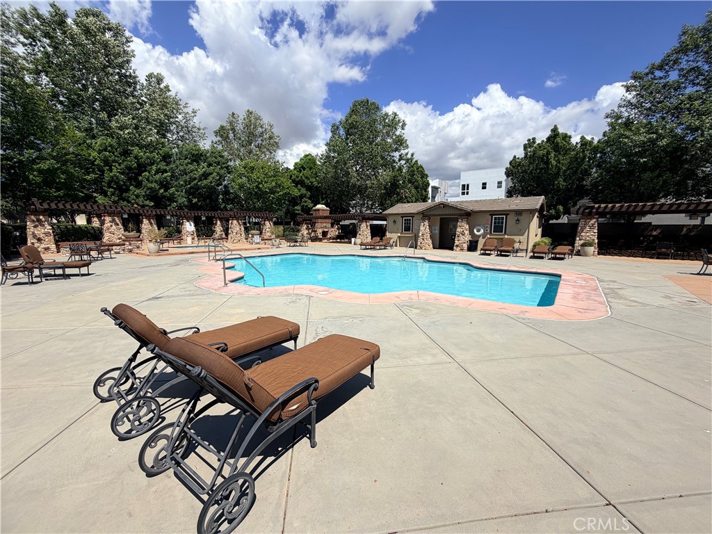 8541 Oak Barrel Place, Unit 2 Rancho Cucamonga, CA 91730 - Photo 31 of 50 a view of a swimming pool with lounge chairs