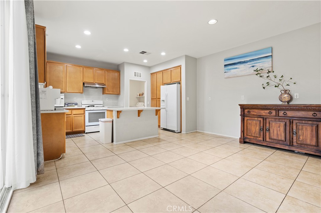 8541 Oak Barrel Place, Unit 2 Rancho Cucamonga, CA 91730 - Photo 4 of 50 a kitchen with stainless steel appliances granite countertop a refrigerator sink and cabinets