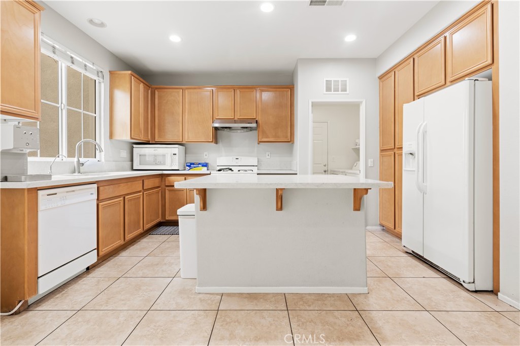 8541 Oak Barrel Place, Unit 2 Rancho Cucamonga, CA 91730 - Photo 8 of 50 a kitchen with stainless steel appliances granite countertop a stove a sink a refrigerator and a refrigerator