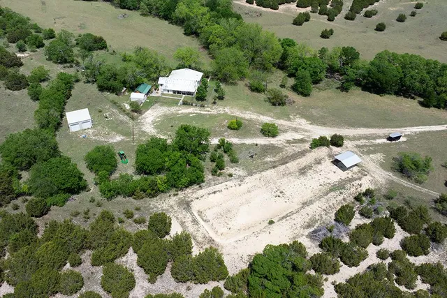 an aerial view of a house with a yard