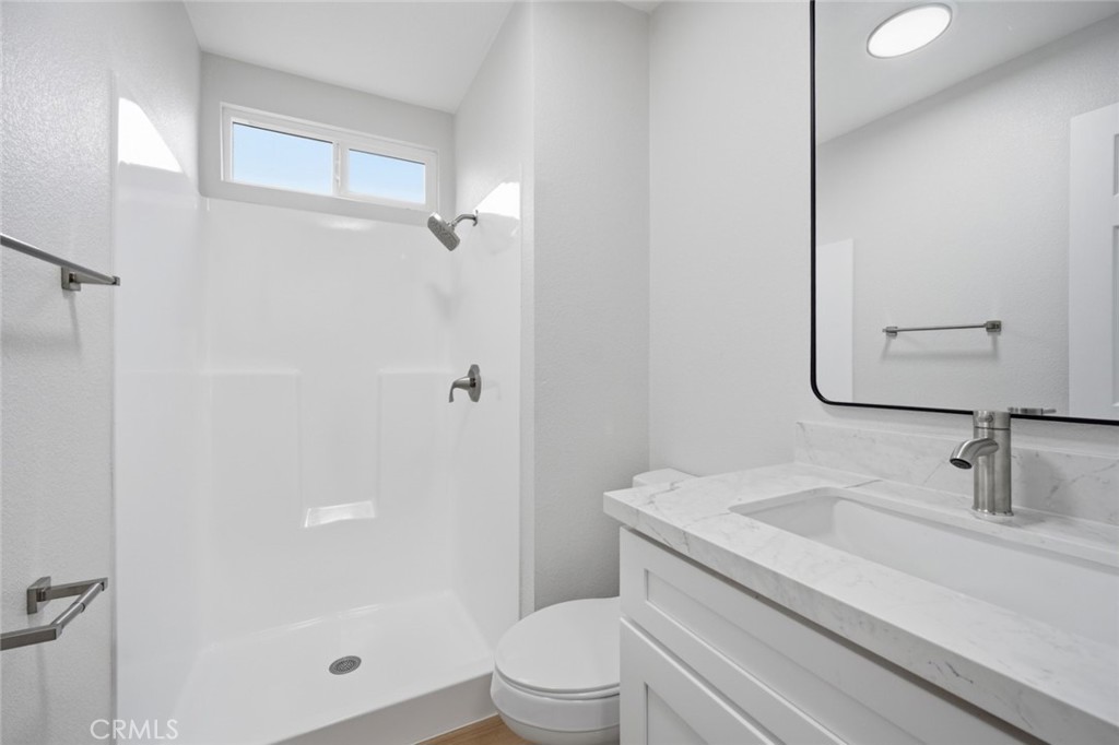 27615 Harrison Avenue Menifee, CA 92585 - Photo 11 of 18 a bathroom with a sink a toilet and shower
