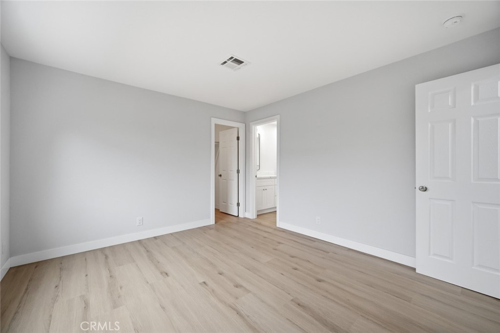 27615 Harrison Avenue Menifee, CA 92585 - Photo 12 of 18 a view of an empty room with wooden floor and a window