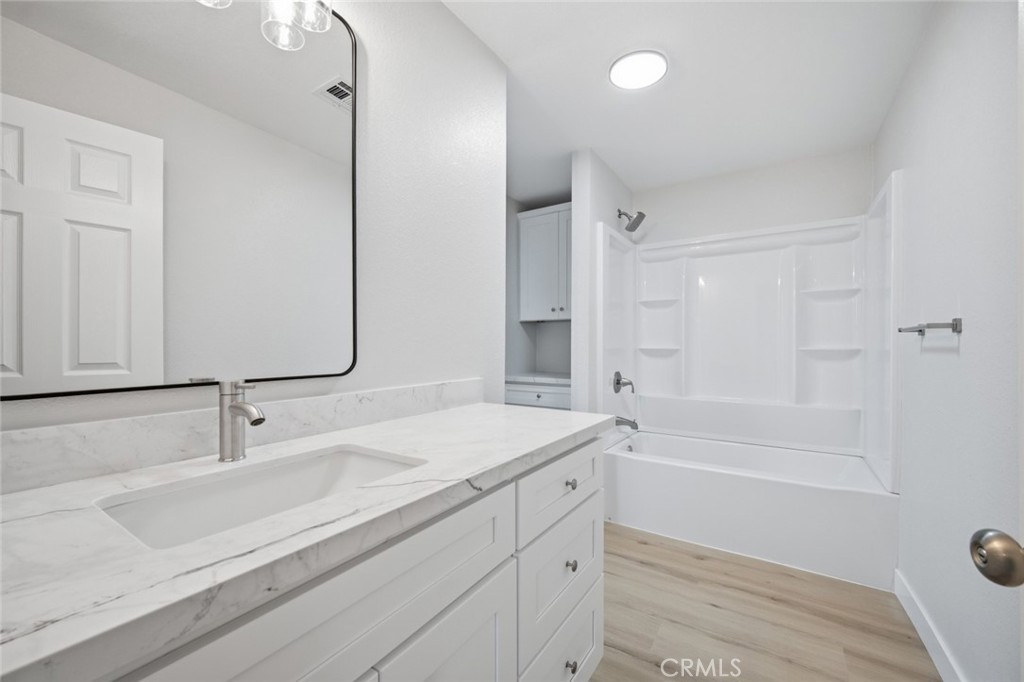27615 Harrison Avenue Menifee, CA 92585 - Photo 13 of 18 a bathroom with a sink double vanity granite tub shower and a mirror