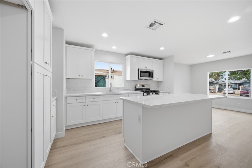 27615 Harrison Avenue Menifee, CA 92585 - Photo 3 of 18 a kitchen with white cabinets and white appliances