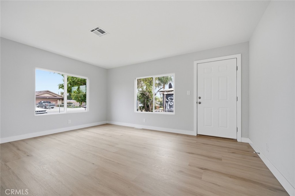 27615 Harrison Avenue Menifee, CA 92585 - Photo 4 of 18 wooden floor in an empty room with a window