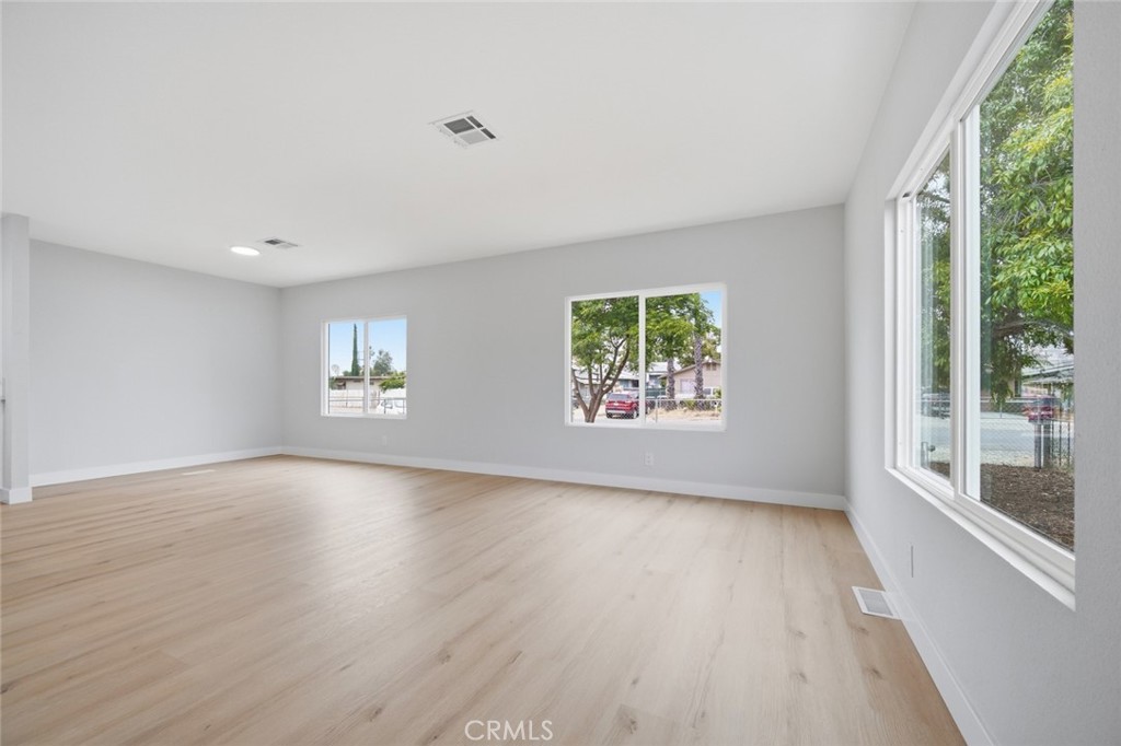 27615 Harrison Avenue Menifee, CA 92585 - Photo 5 of 18 wooden floor in an empty room with a window
