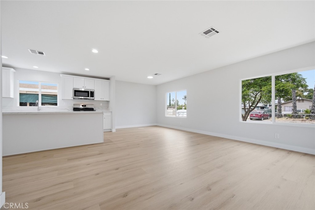 27615 Harrison Avenue Menifee, CA 92585 - Photo 6 of 18 wooden floor in an empty room with a window