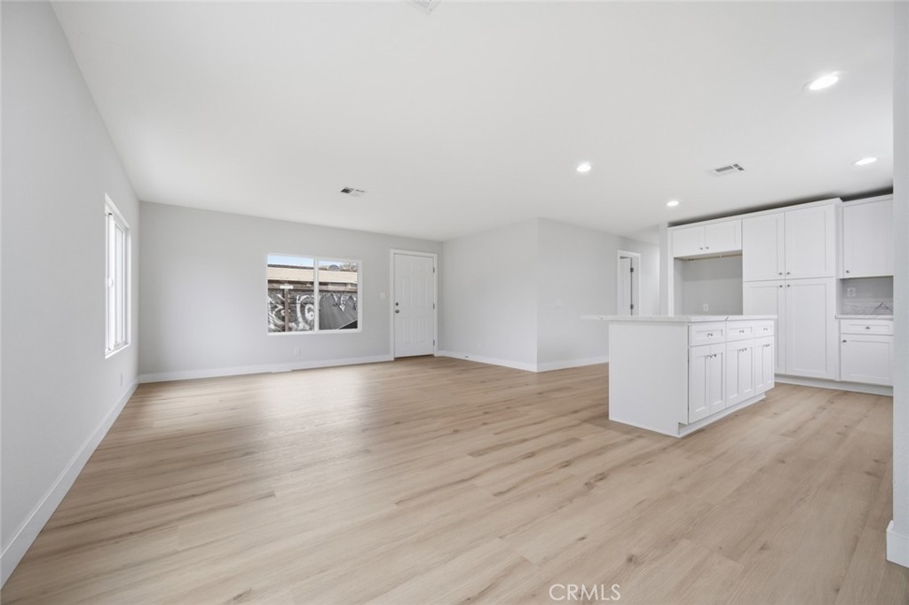 27615 Harrison Avenue Menifee, CA 92585 - Photo 7 of 18 a view of an empty room with a window and wooden floor