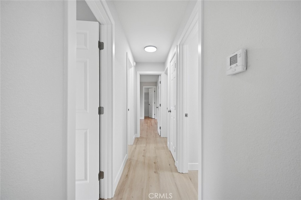 27615 Harrison Avenue Menifee, CA 92585 - Photo 9 of 18 a view of a hallway with wooden floor