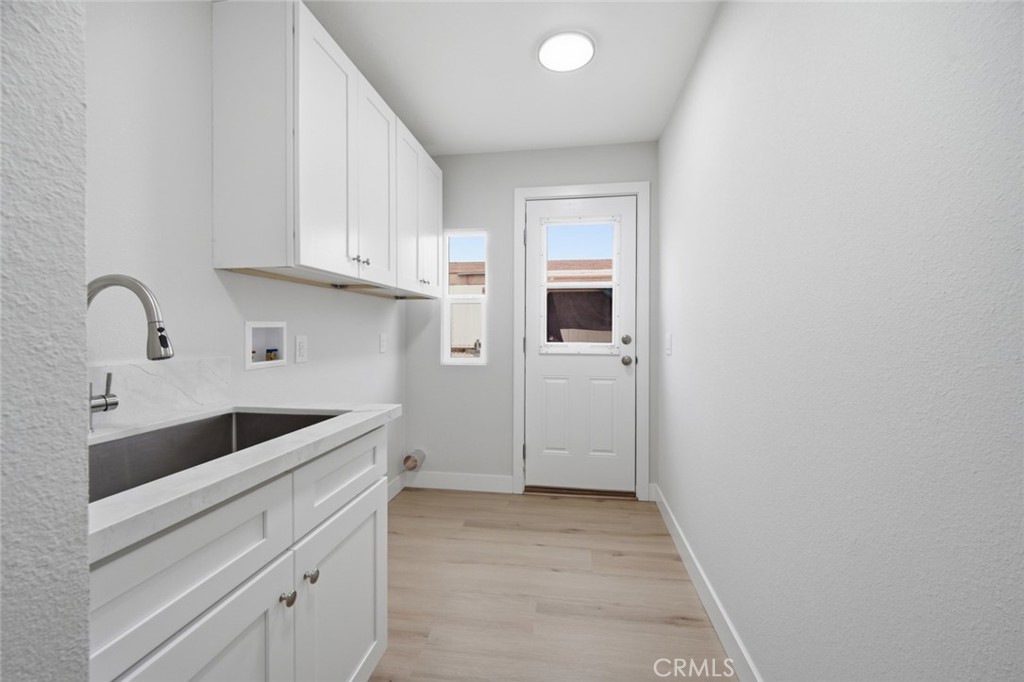27615 Harrison Avenue Menifee, CA 92585 - Photo 10 of 18 a kitchen with granite countertop a sink and cabinets