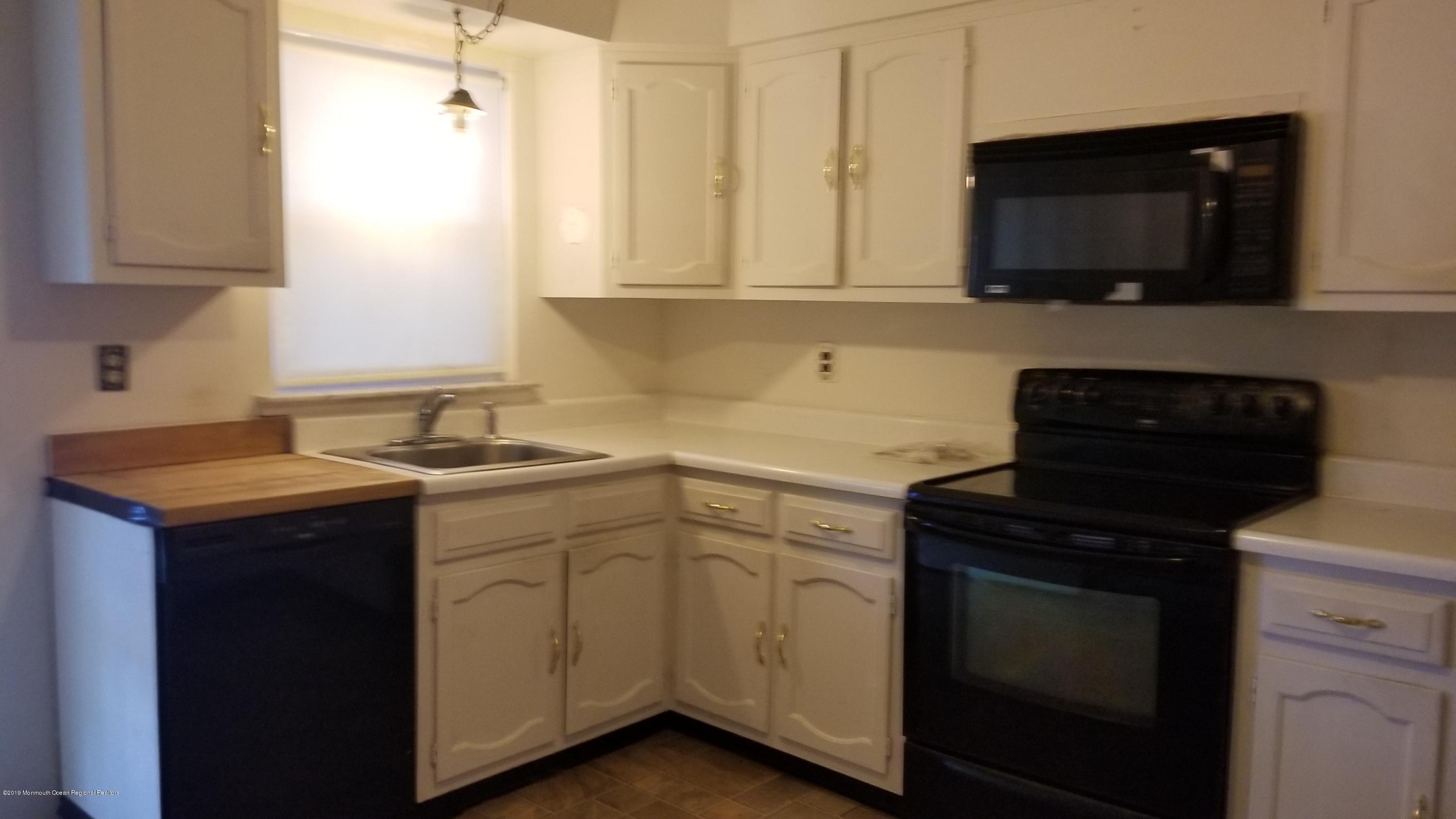 2 Conestoga Drive, Unit A Whiting, NJ 08759 - Photo 3 of 12 a kitchen with sink cabinets and microwave
