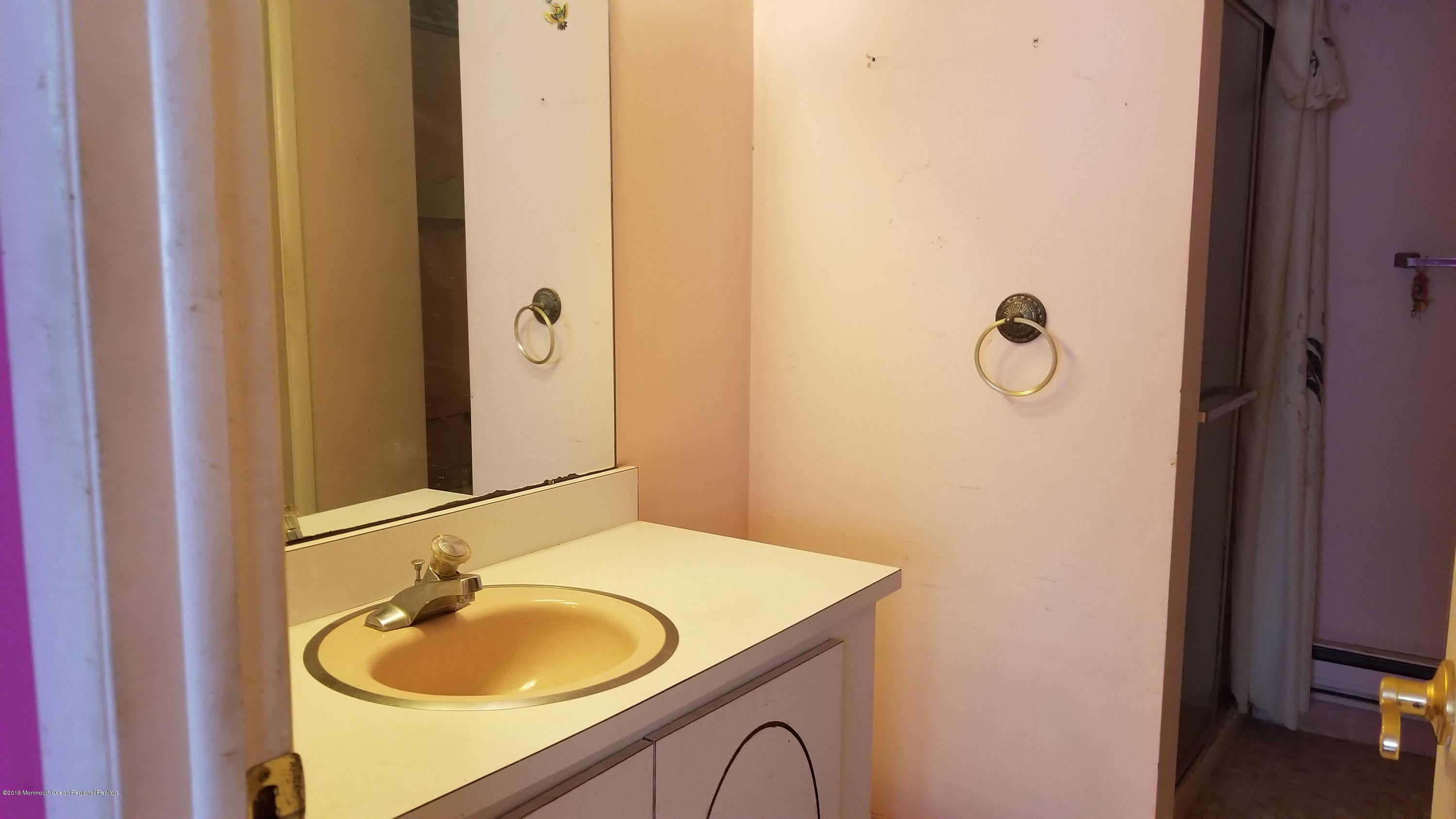 2 Conestoga Drive, Unit A Whiting, NJ 08759 - Photo 10 of 12 a bathroom with a sink and a mirror