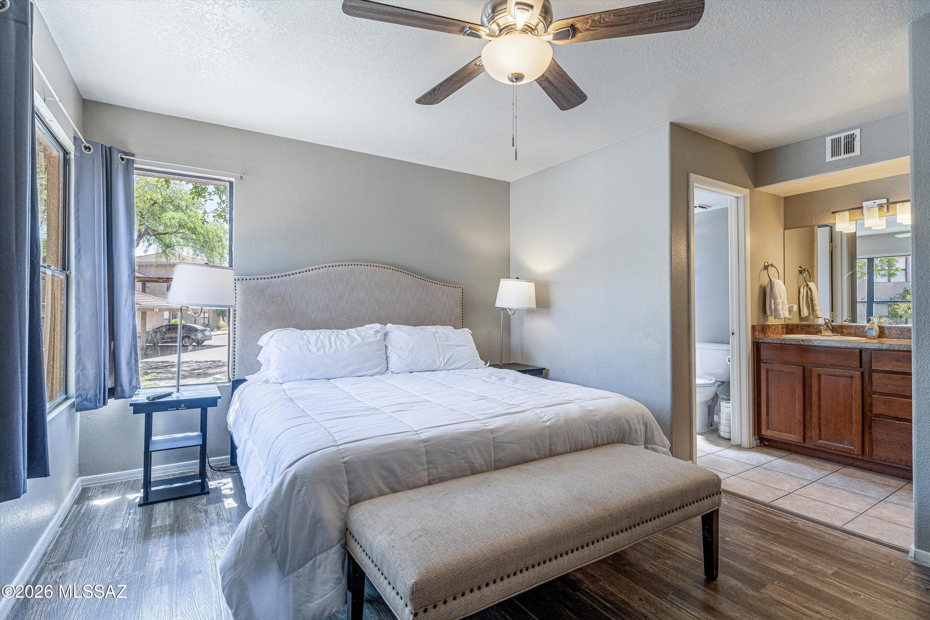 5855 North Kolb Road, Unit 8106 Tucson, AZ 85750 - Photo 17 of 34 a bedroom with a bed and a chandelier