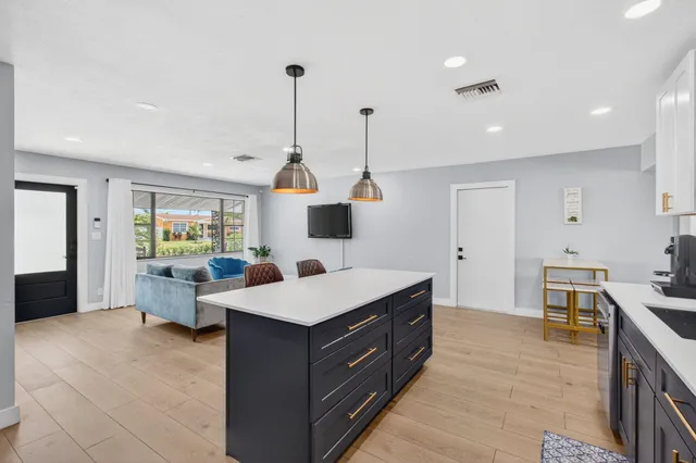 a large room with a large bed and a chandelier