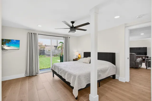 a living room with a bed furniture and a large window