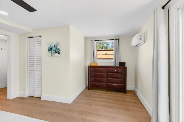 an empty room with windows and closet