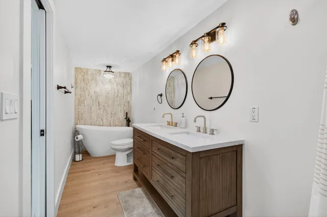 a bathroom with a toilet a sink and a mirror