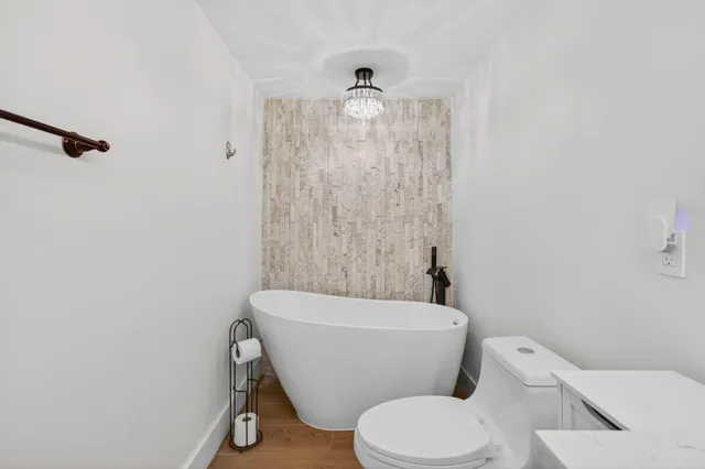 a white toilet sitting next to a bathroom sink