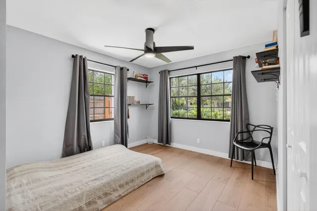 a bedroom with a bed and a window