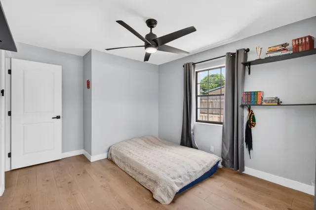 a bedroom with a bed and a window