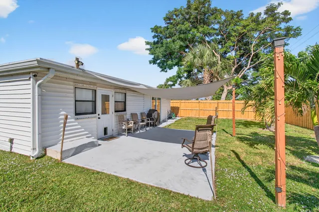 a view of backyard with a patio