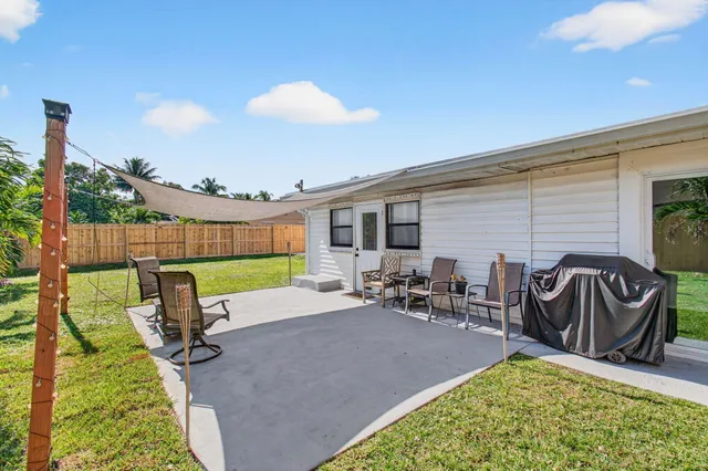 a backyard of a house with yard fire pit and chairs