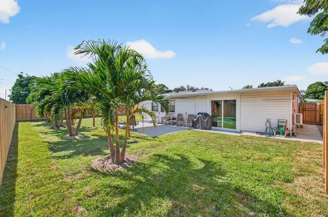 a backyard of a house with table and chairs