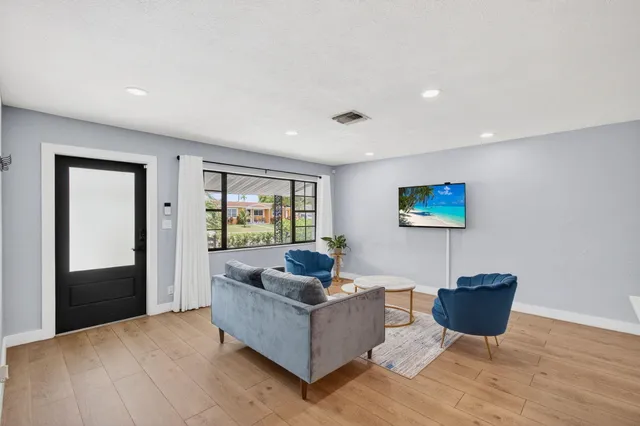 a living room with furniture a rug and a window