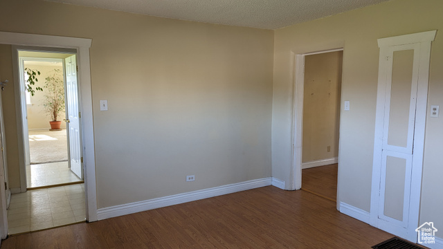 1341 East Crk Road Sandy, UT 84093 - Photo 17 of 24 Spare room featuring wood finished floors and baseboards