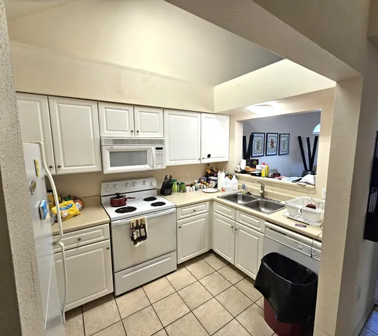 a kitchen with appliances cabinets and a sink