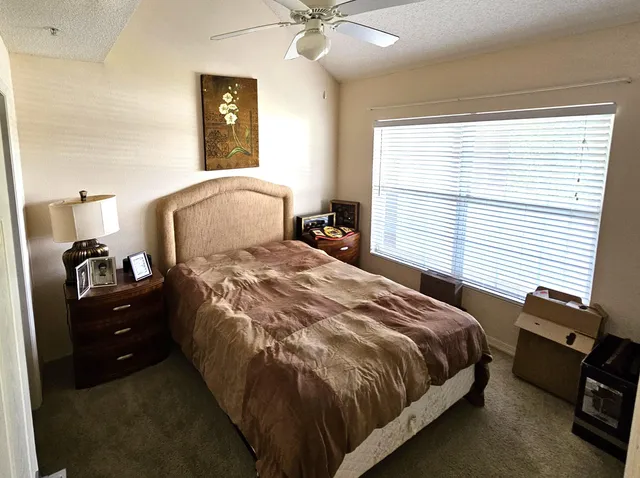 a bedroom with a bed and window