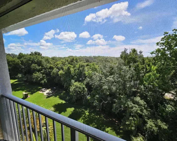 a view of a balcony with a yard
