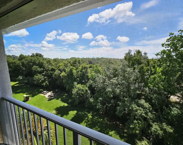 a view of a balcony with a yard