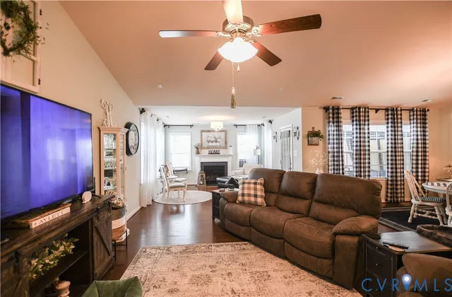 a living room with furniture wooden floor and chandelier