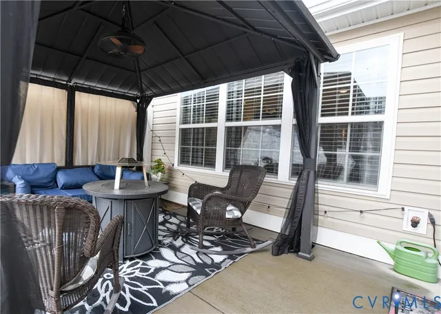 a view of a chairs and table in patio