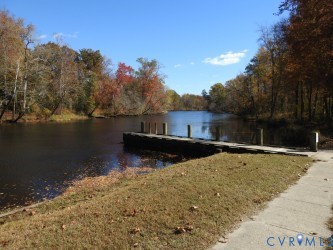 696 Anne Lane Aylett, VA 23009 - Photo 25 of 27 a view of a lake with a house in the background